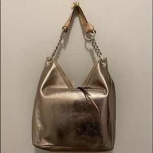 Jimmy Choo bronze metallic handbag silver accents Has two zipper closures.
